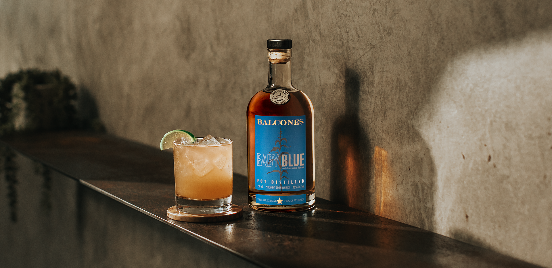 Bottle of Texas 1 Single Malt Whisky with Imposterita Cocktail on Table