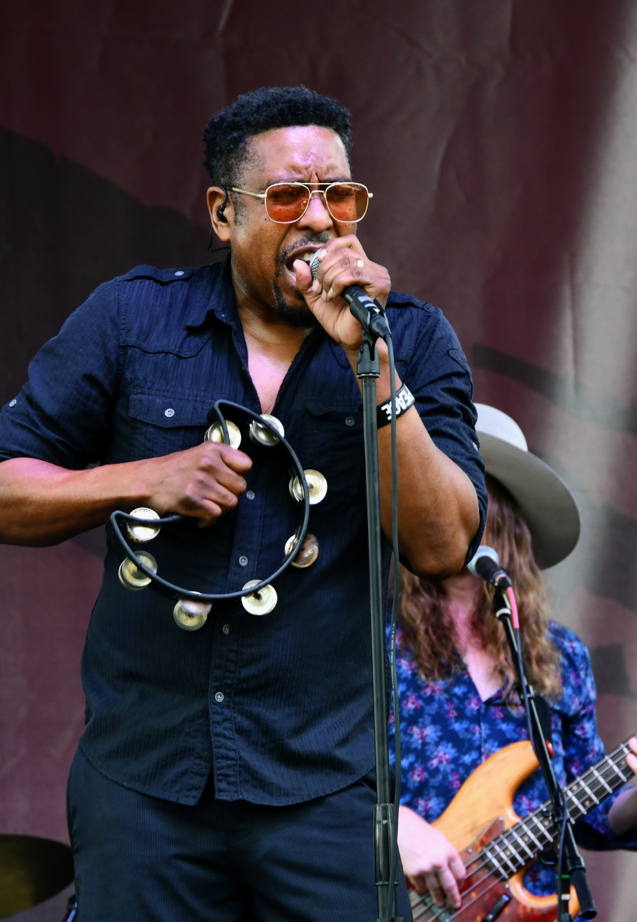 Man singing into microphone on stage