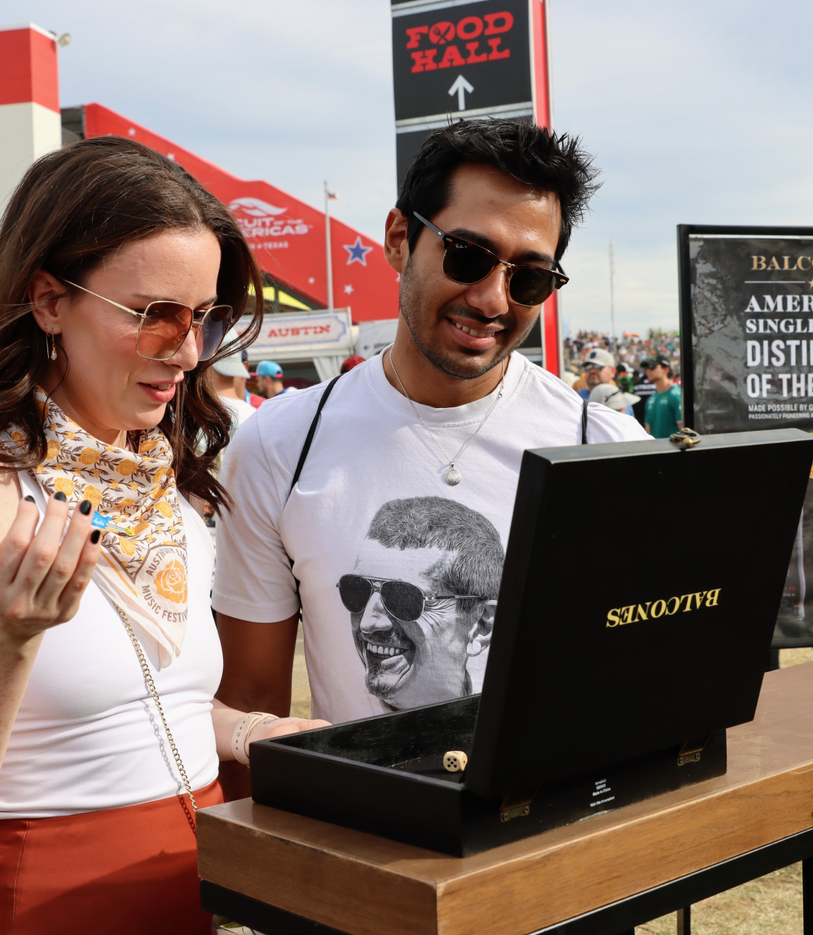 Two attendees playing a Balcones' dice game