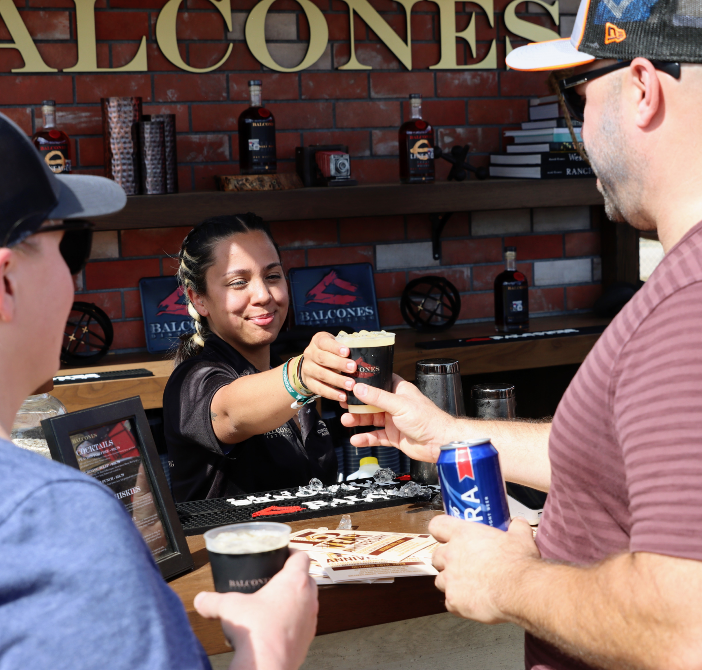 Bartender handing customer a drink