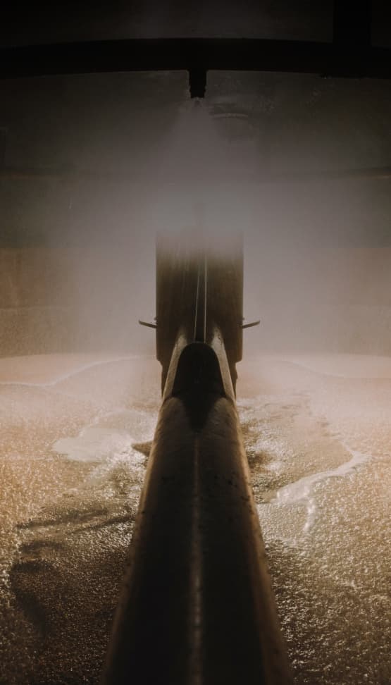 machine milling barley in a vat