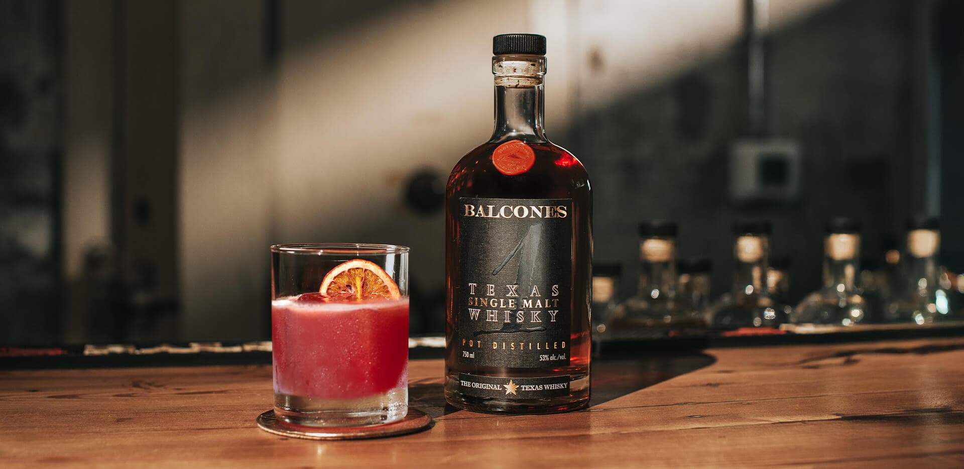 Bottle of Texas 1 Single Malt Whisky with Old Fashioned on Table