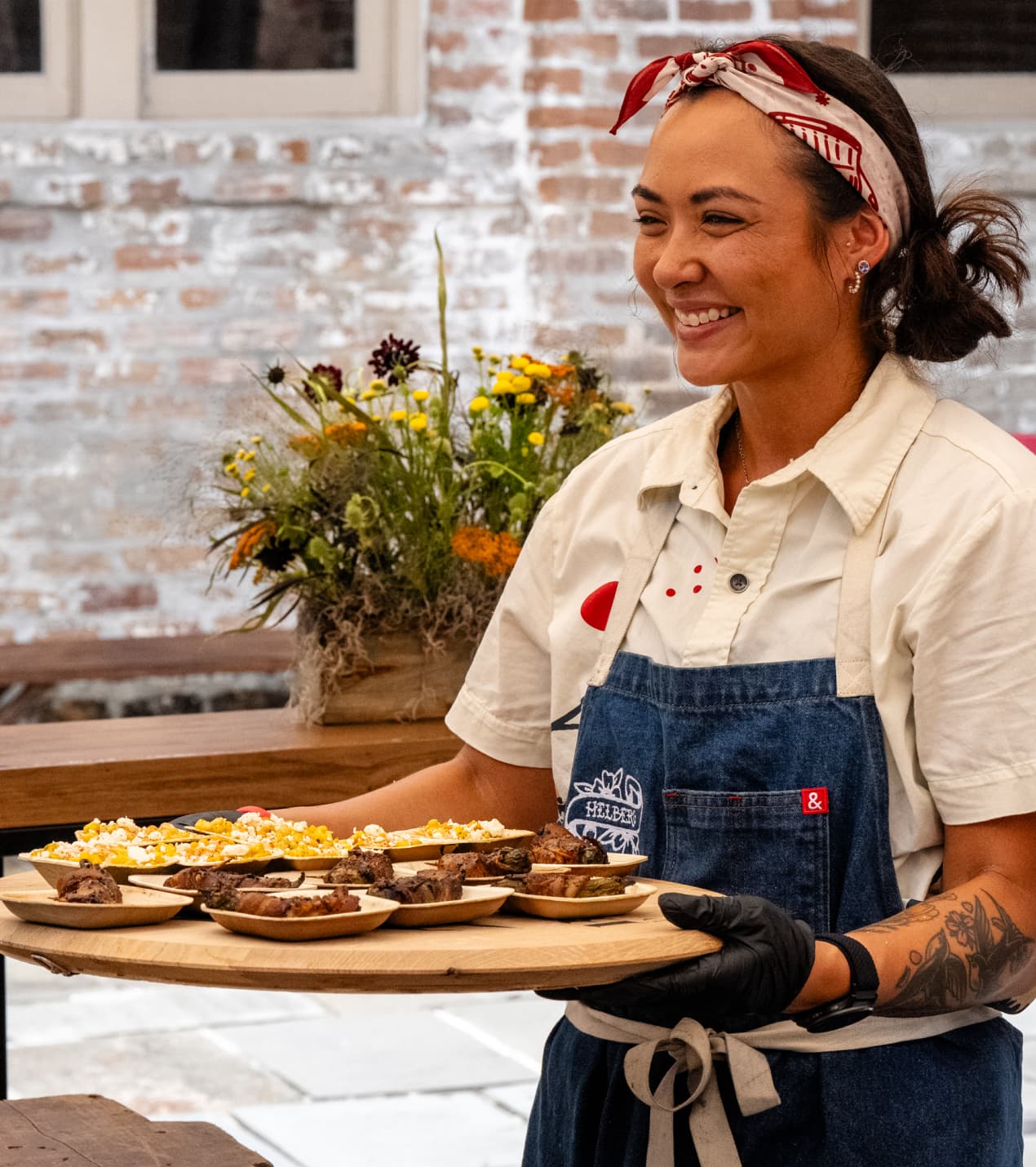 Two women holding cocktails and smiling at camera