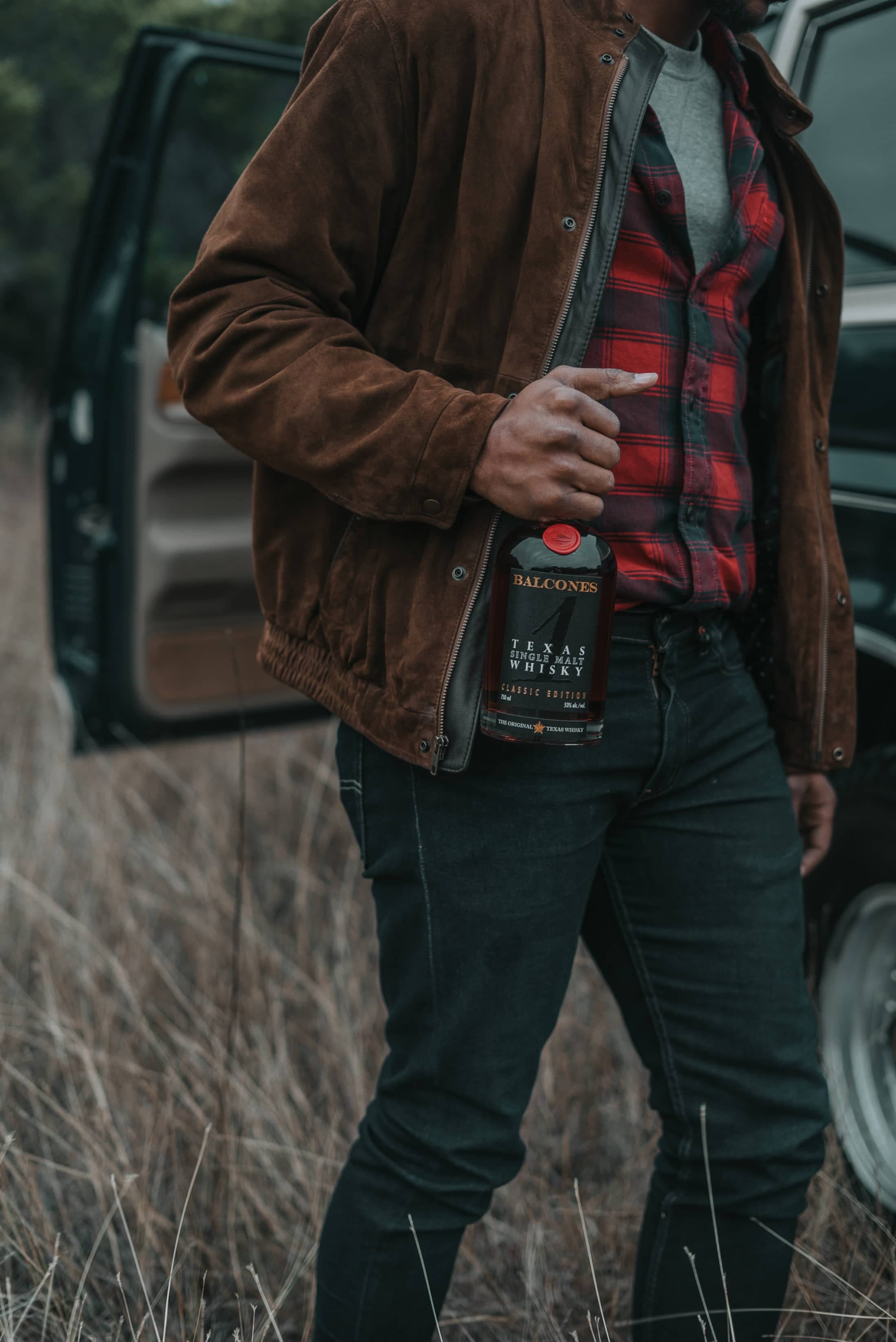 Man carrying bottle of Texas 1 Single Malt Whisky